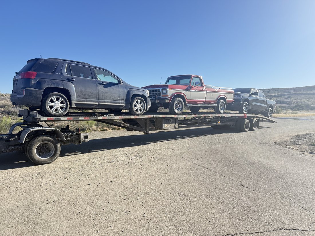 Three vehicles on gooseneck car hauler