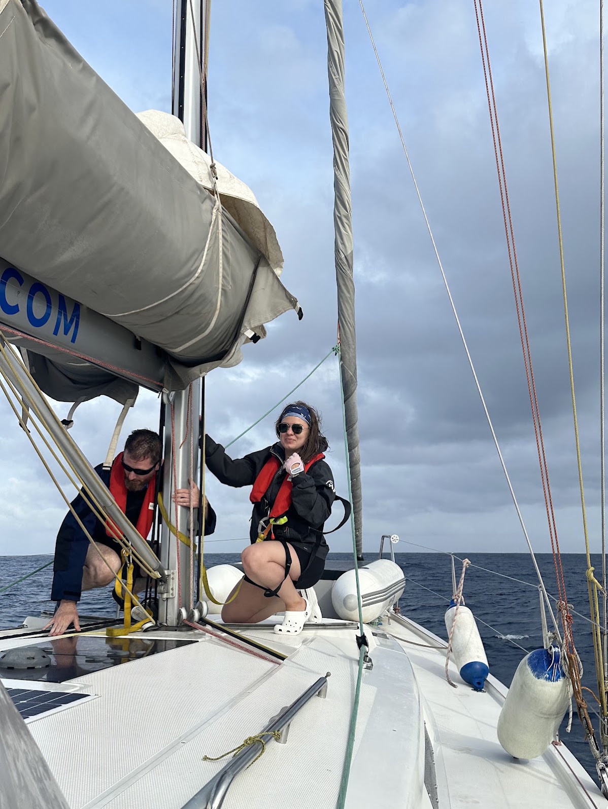 Guests on the foredeck under the sails