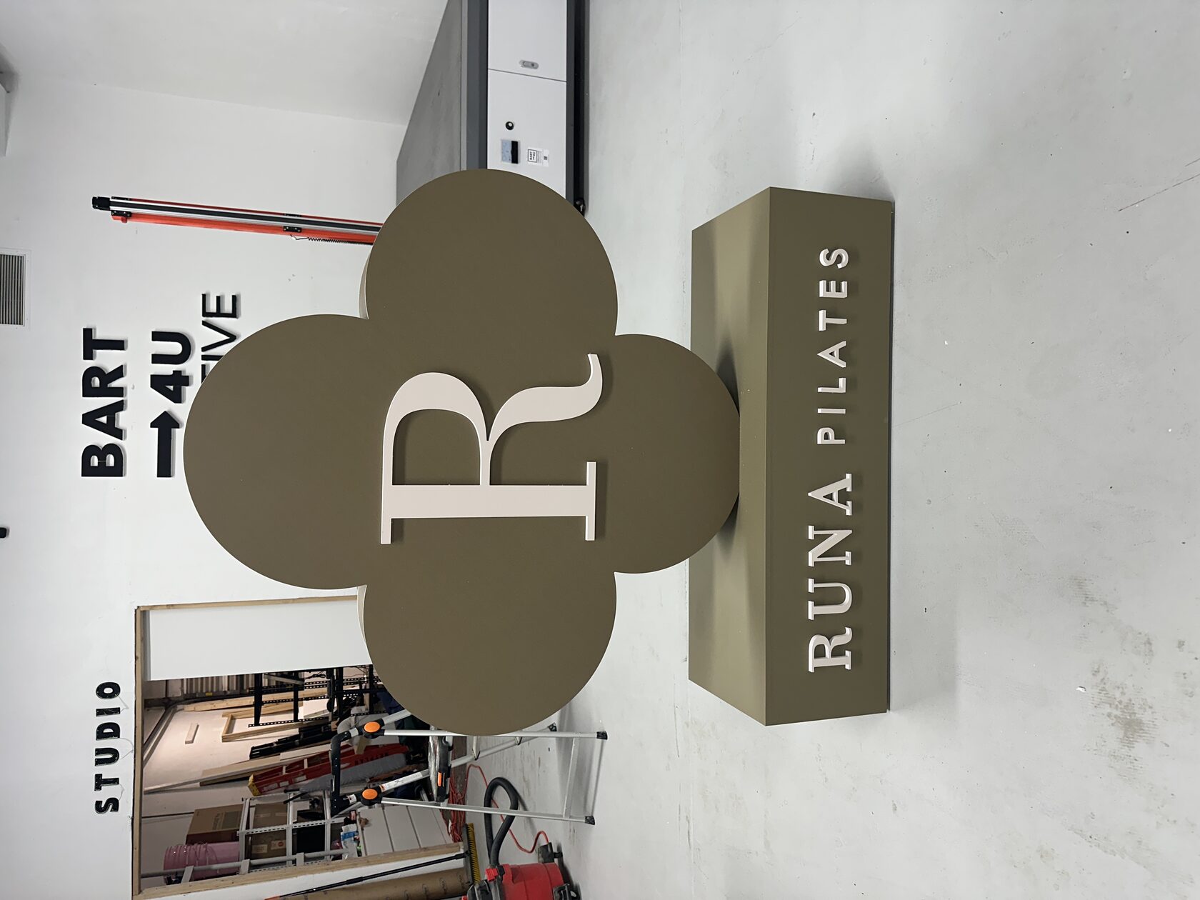 Completed RUNA Pilates freestanding PVC logo with dimensional lettering and branded base for Edgewater Miami