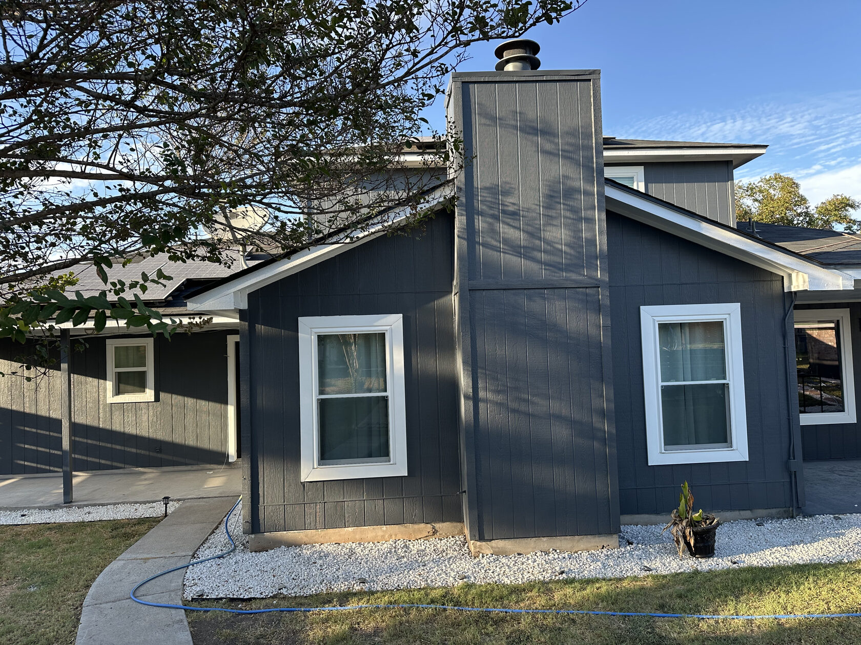 Two-story exterior house painting project in Austin TX by Kir Remodeling