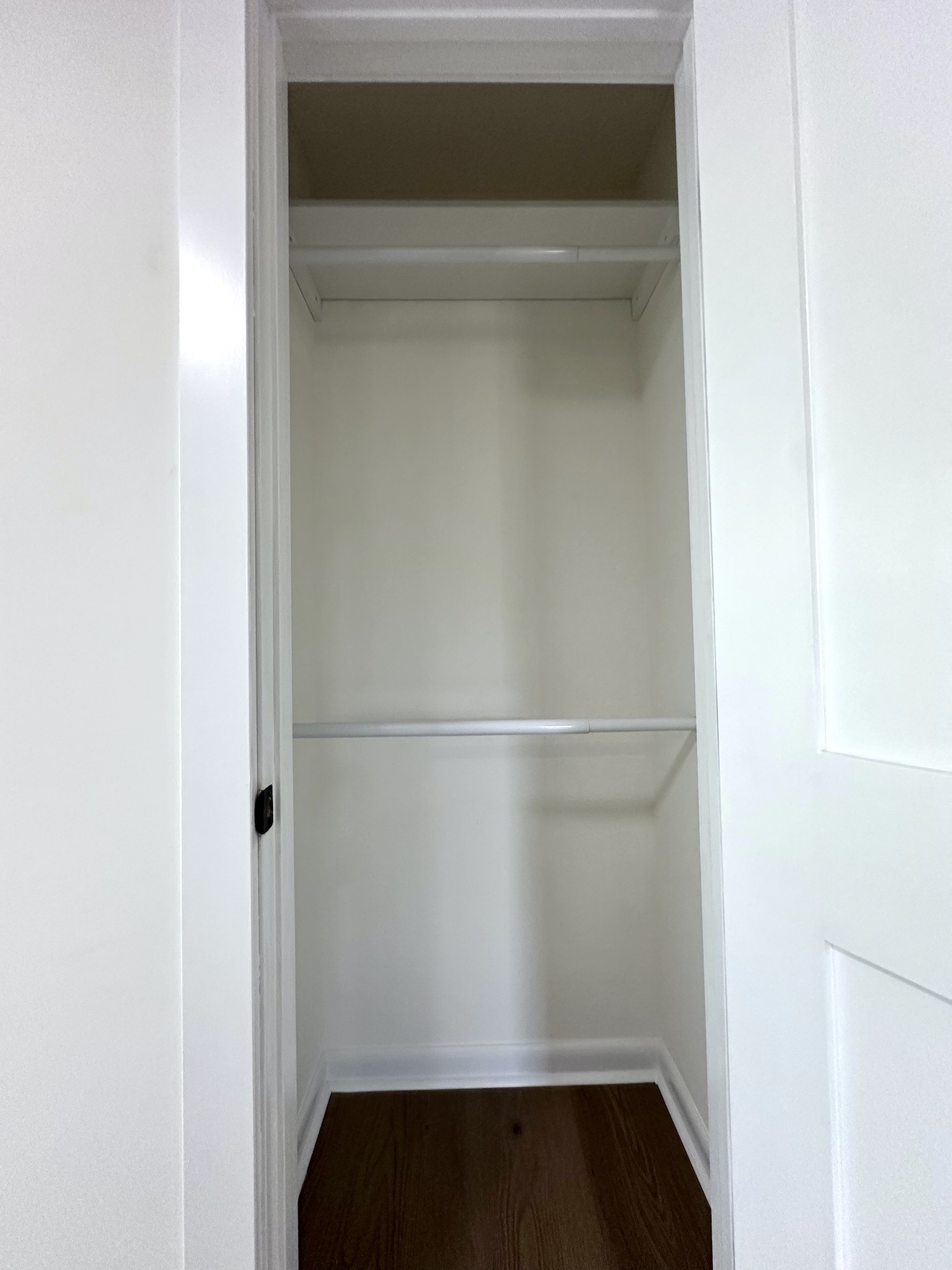 Finished closet with shelving, hanging rod and new bifold doors