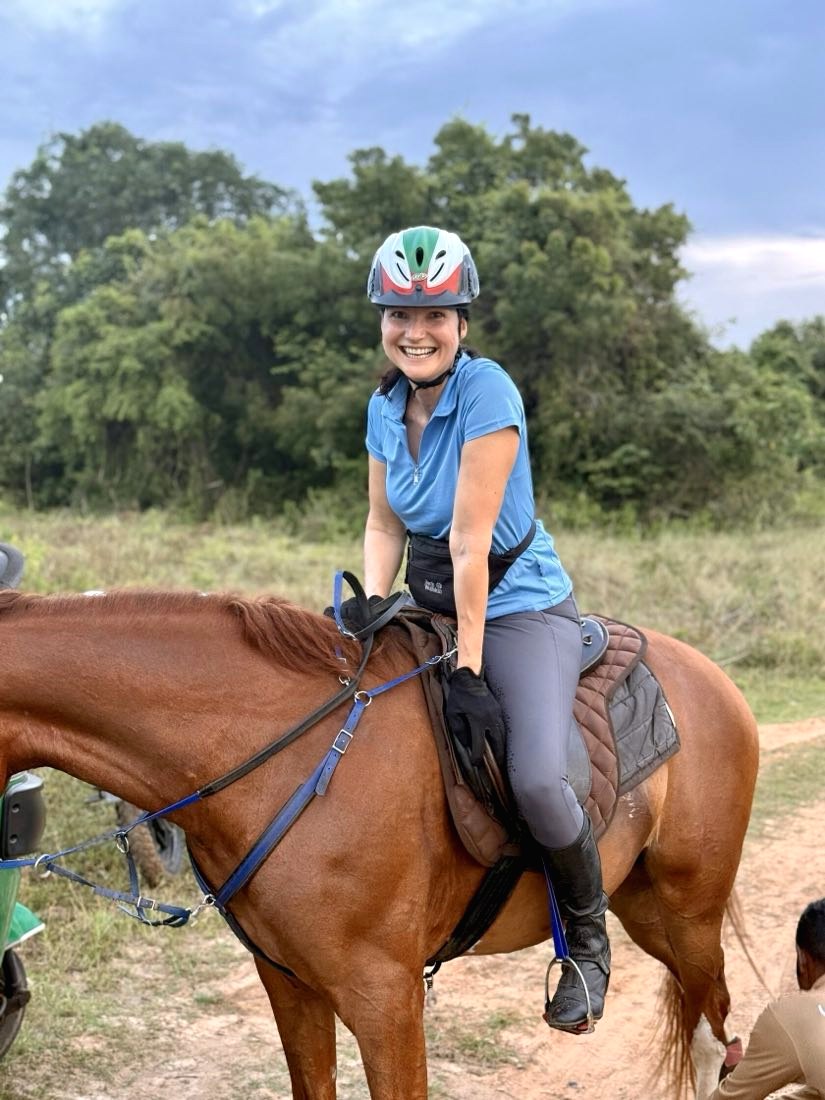 A helmeted rider on a Ranch trail ride.