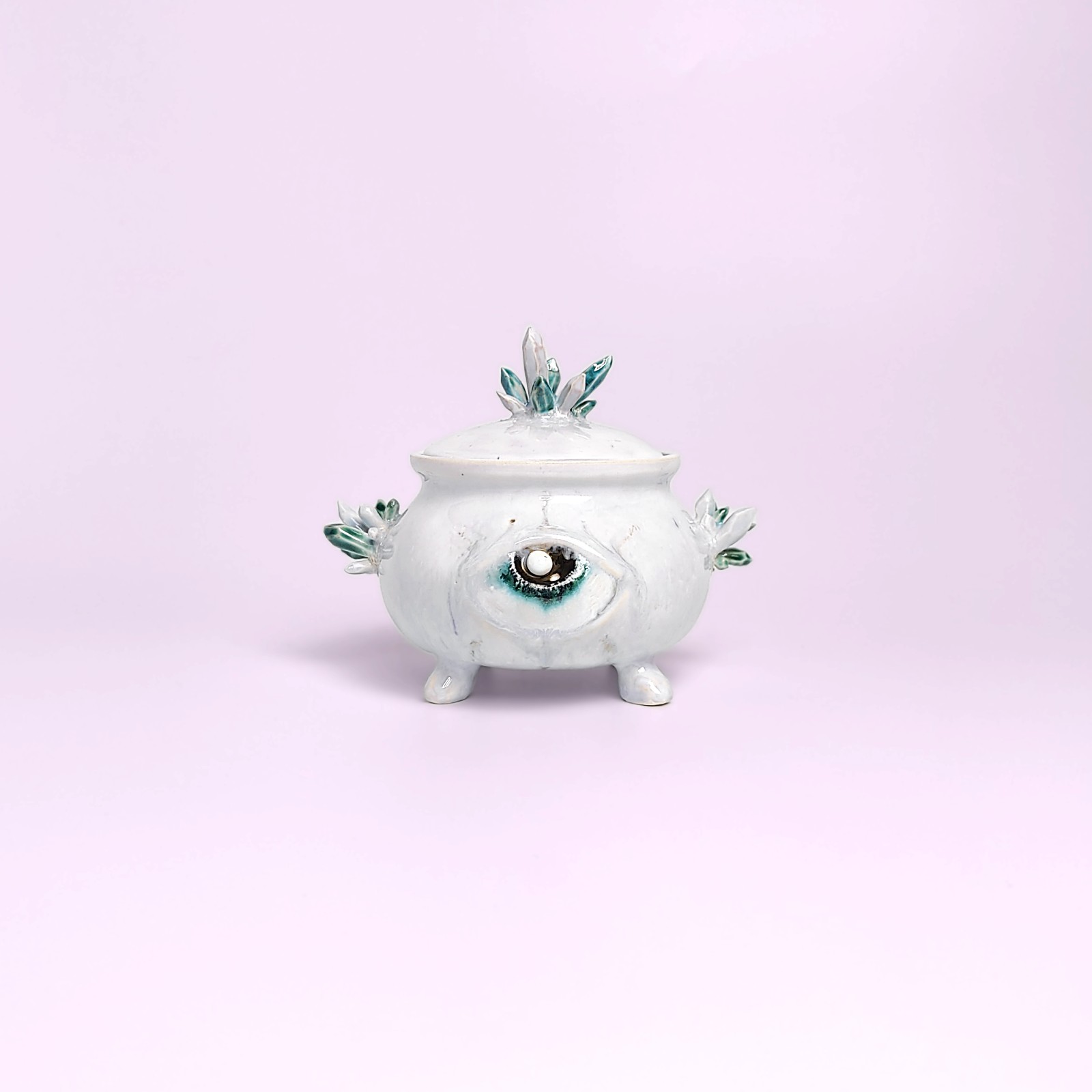 unique witchy handmade ceramic sugar bowl with a sculpted magical eye, green crystal details, and soft white glaze