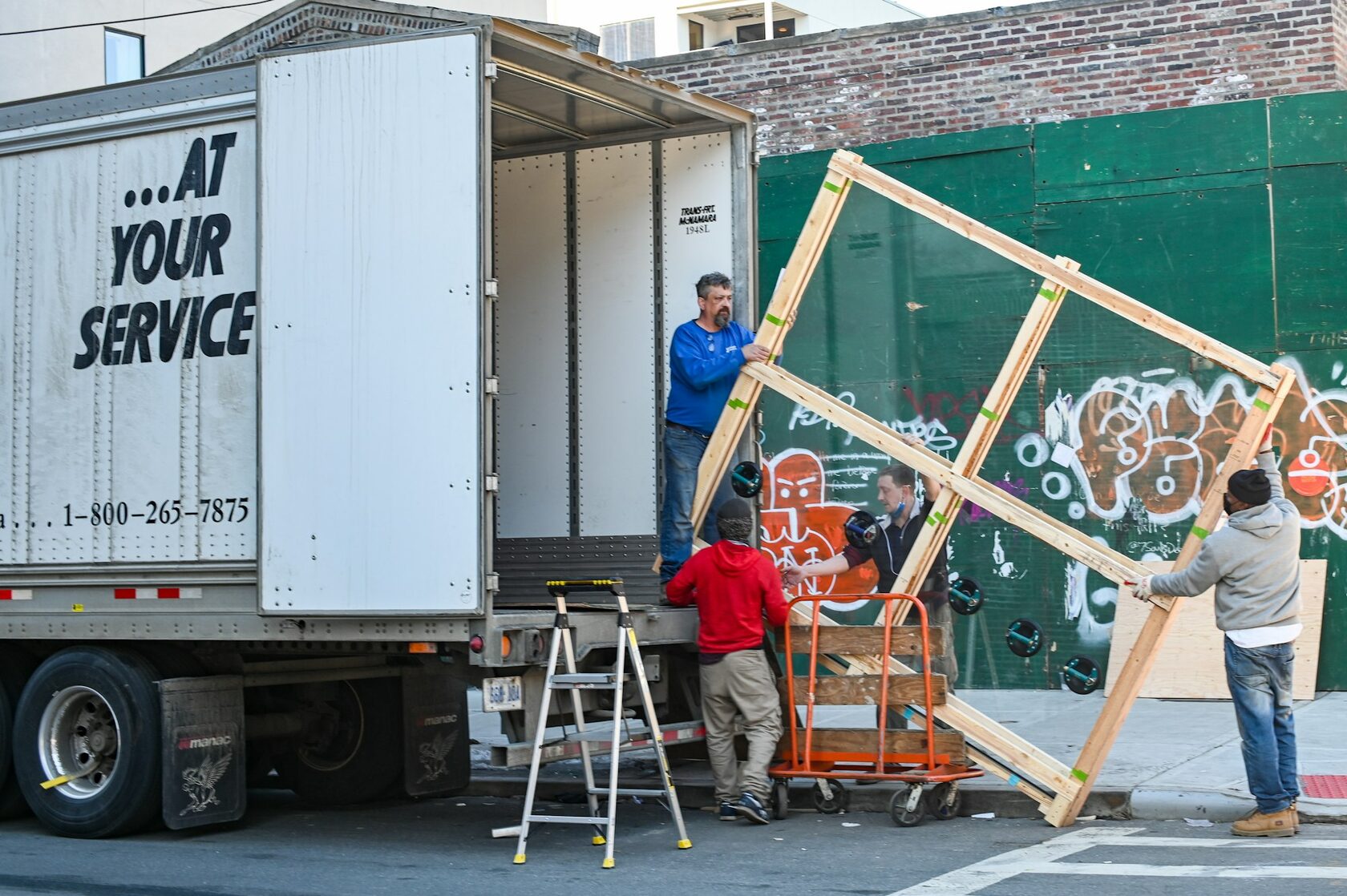 Old sofa being loaded into a truck for removal
