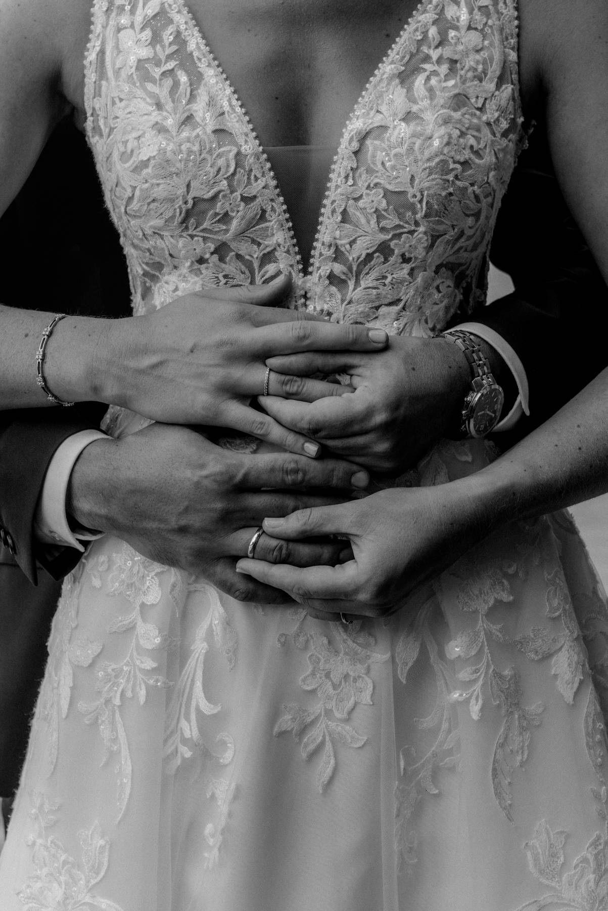 Romantic after‑wedding kiss under a veil — couple at dusk with mountain backdrop.