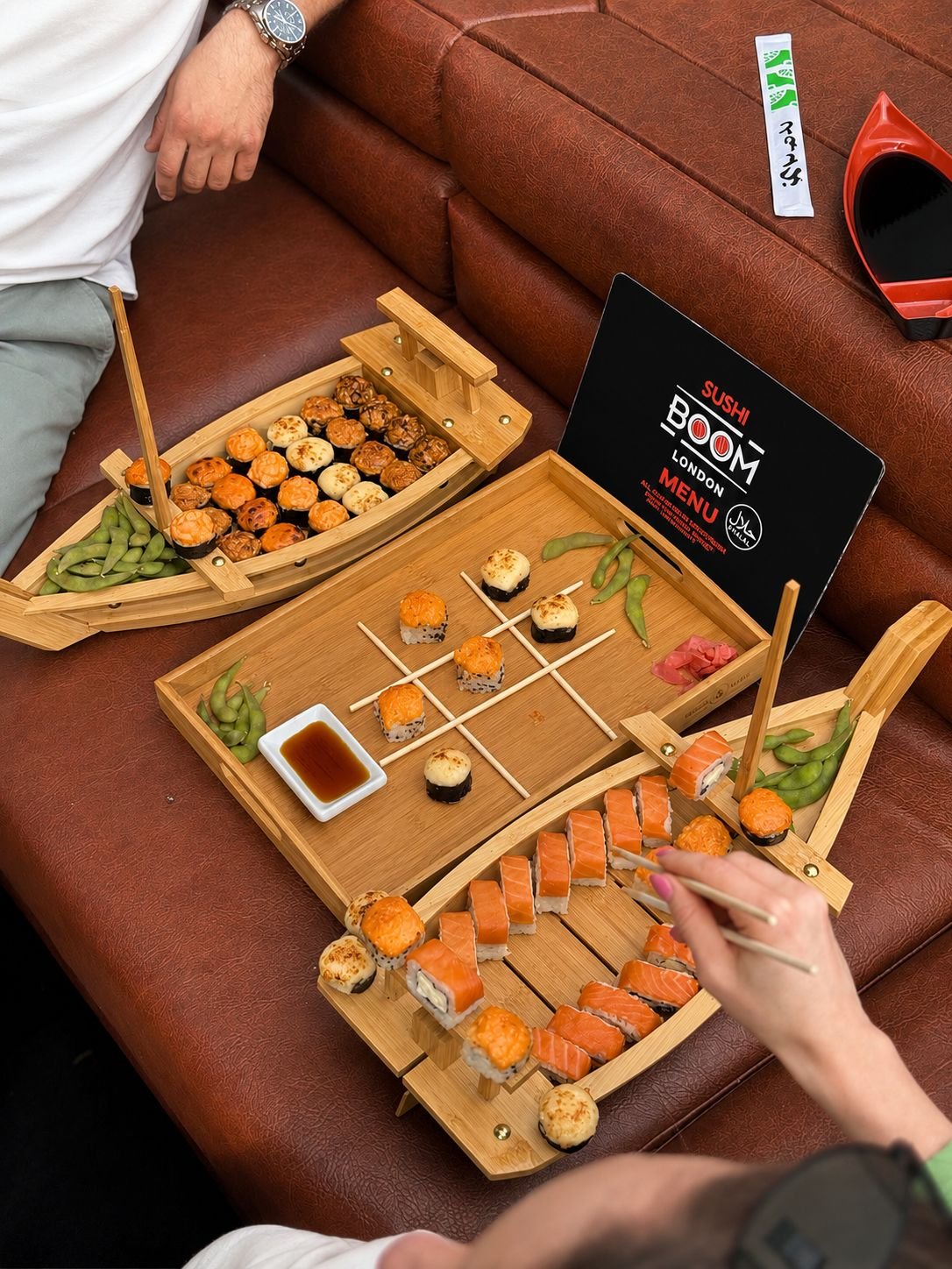 Couple kissing aboard the boat with sushi tray