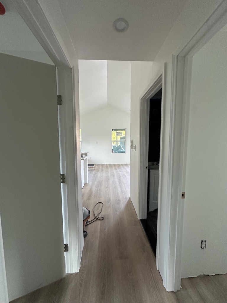 Hallway finish stage · New LVP and paint — Austin house flip by Kir Remodeling