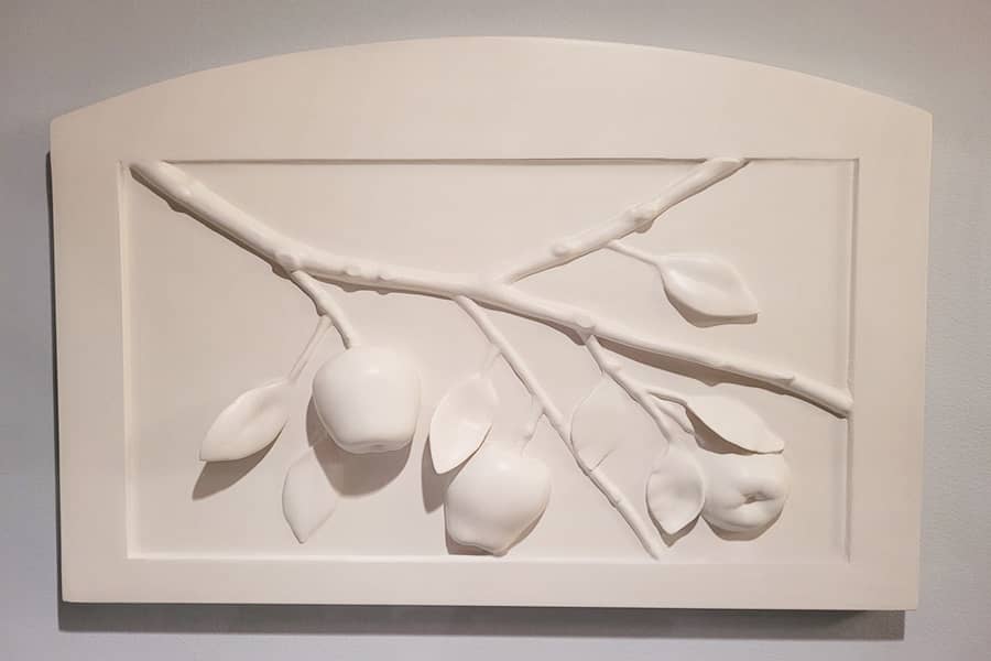 Decorative wall plaque of bas relief of apple branch with arched frame in white 