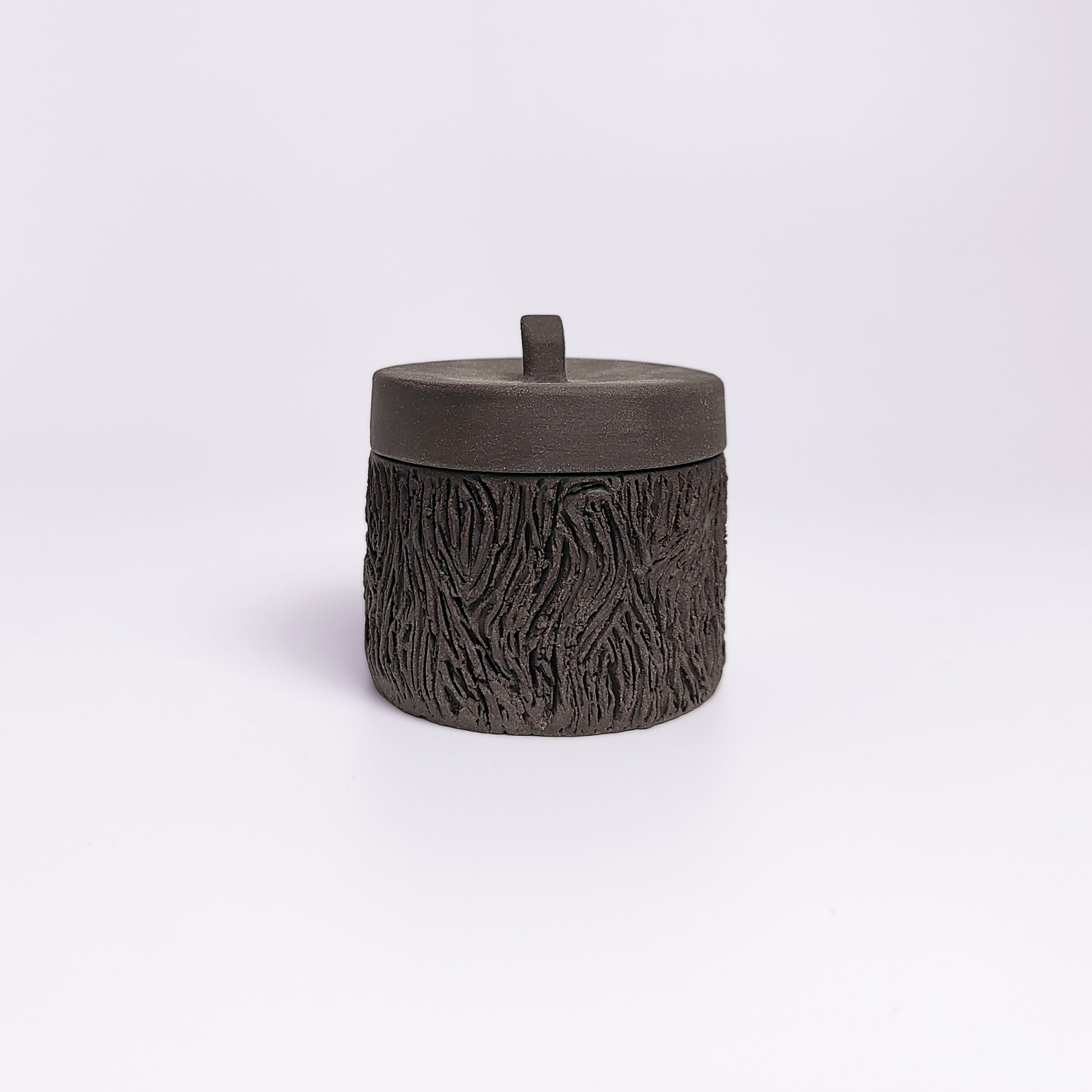 dark witchy-style ceramic box with carved wood-like texture and mystical violet glaze