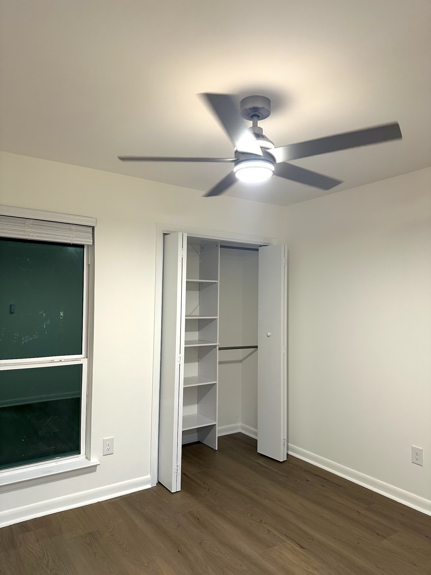 Renovated bedroom with smooth ceiling, painted walls, new window and closet storage