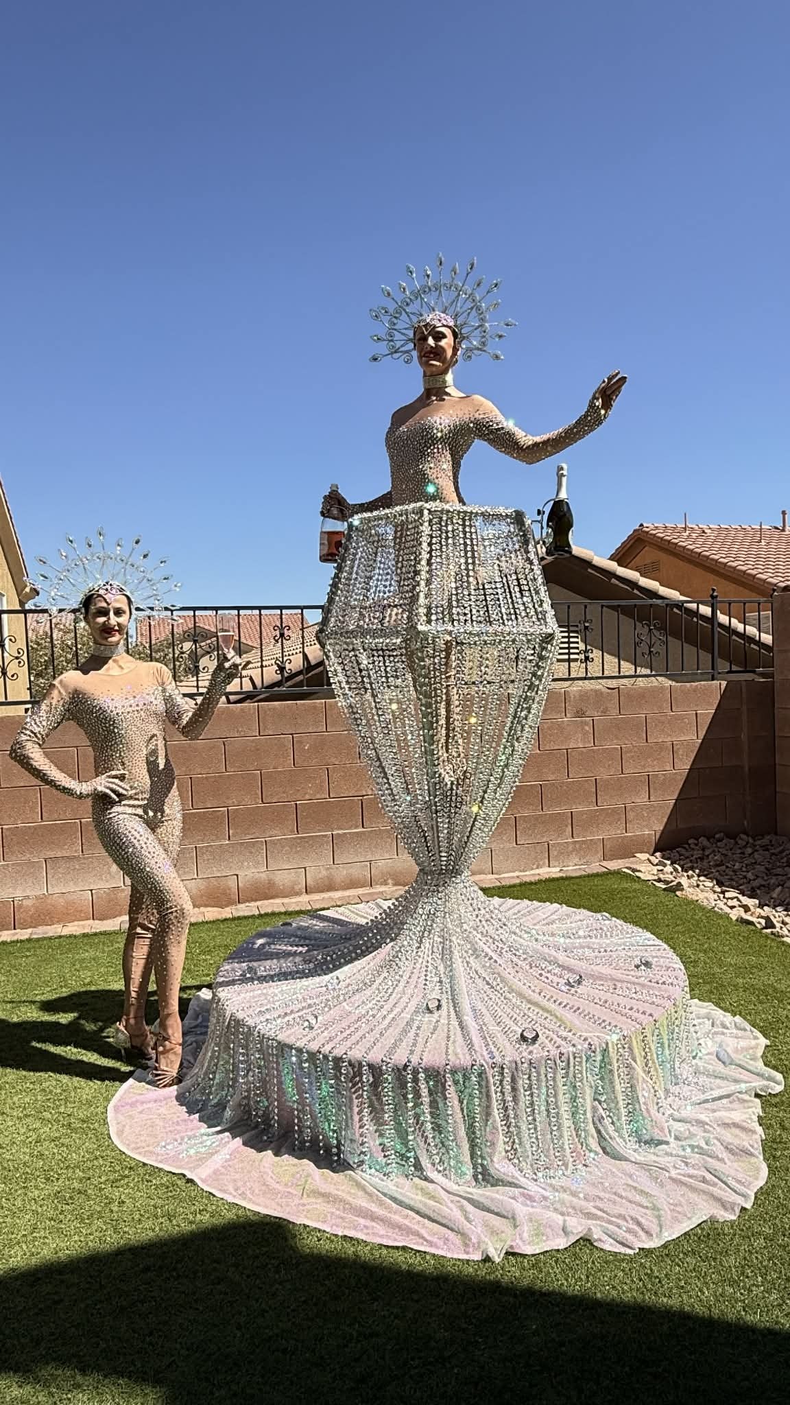 Champagne pour performance with crystal headdresses