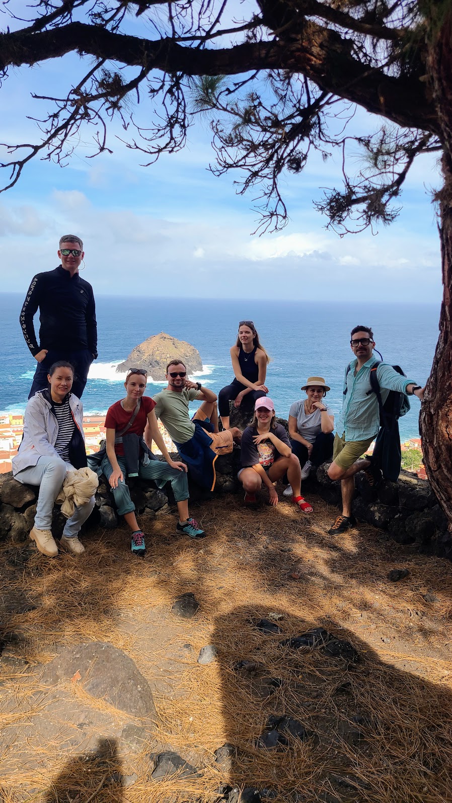 Group resting on rocks above the sea after a hike
