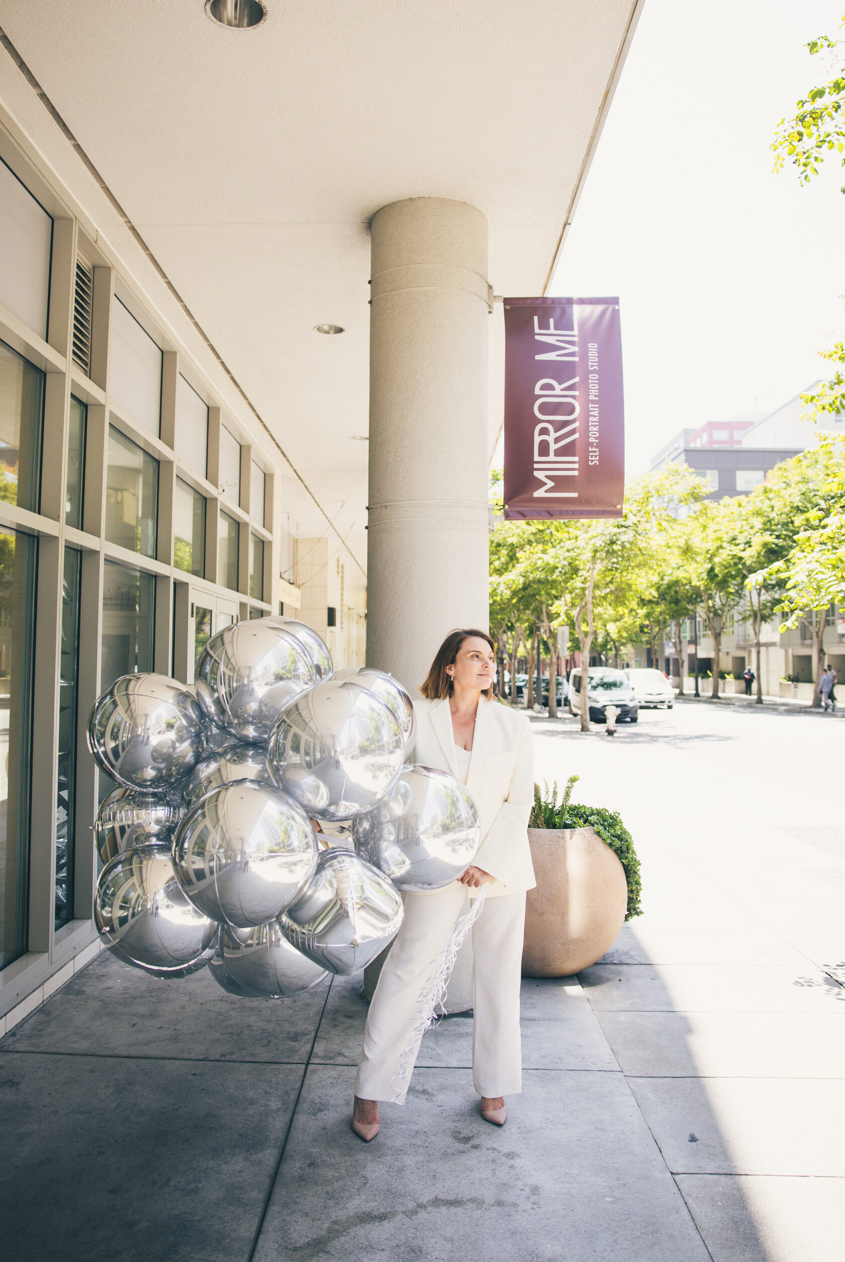Woman taking photos in a private self-portrait studio without a photographer in San Francisco