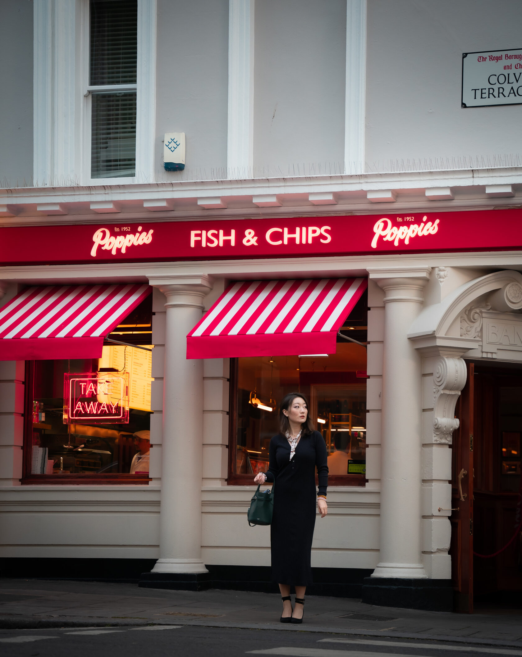 London street portrait outside a red-fronted fish and chip shop