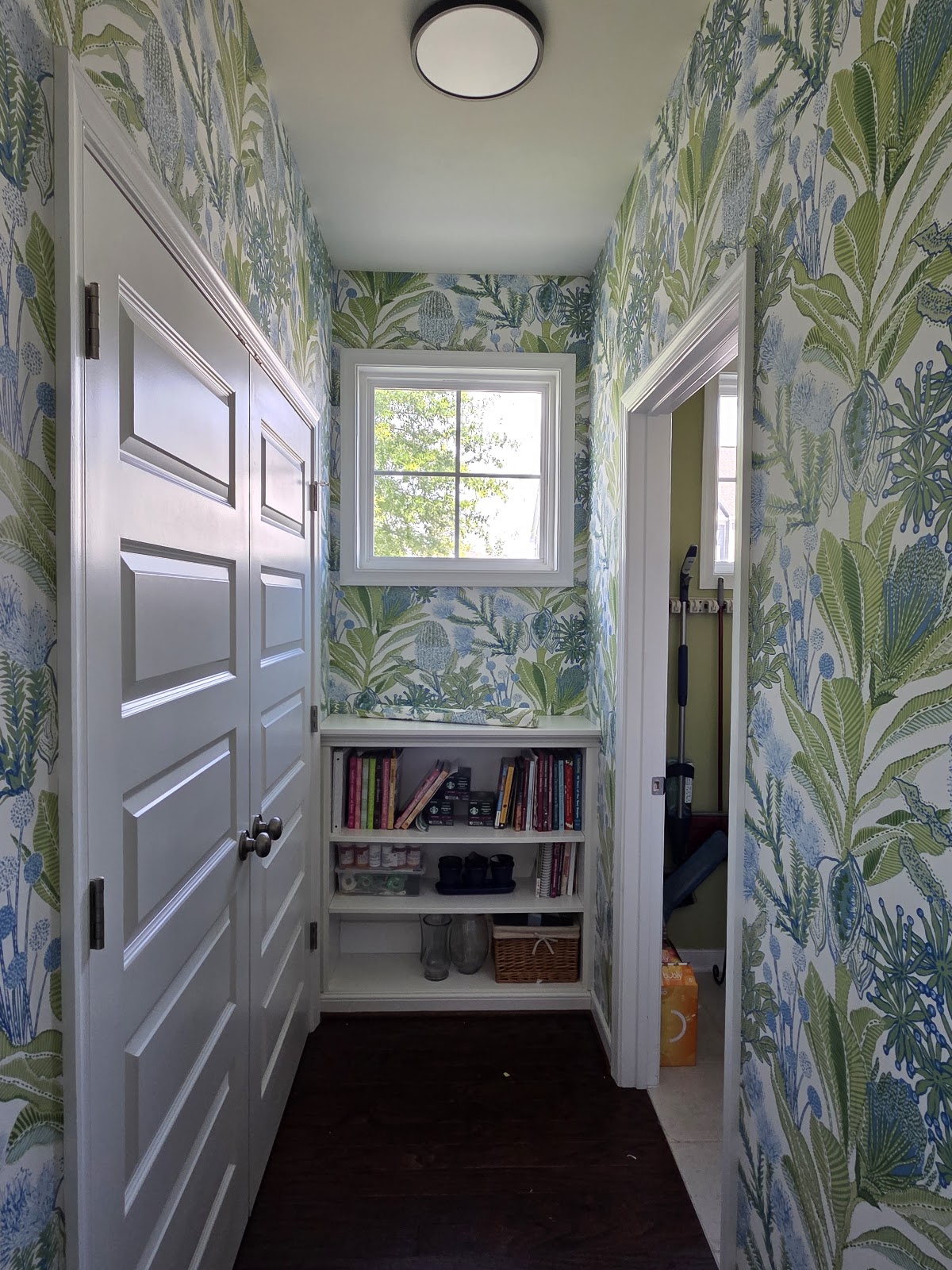 Botanical wallpaper installed in a hallway with built-in shelves — wallpaper installation in Charlottesville, Virginia by Studio 7 Walls