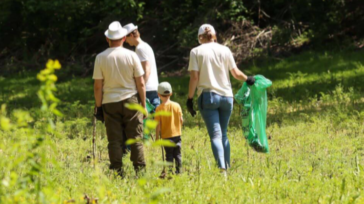 Environmental team building. People travel, walk through fields with their family, and socialize