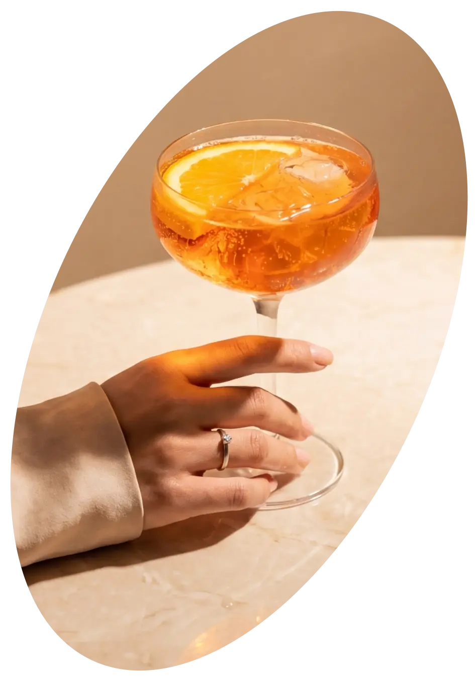 A martini glass sits on a concrete pedestal