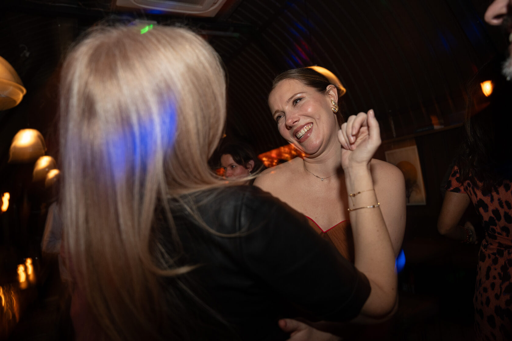 Guests talking and smiling during an evening event