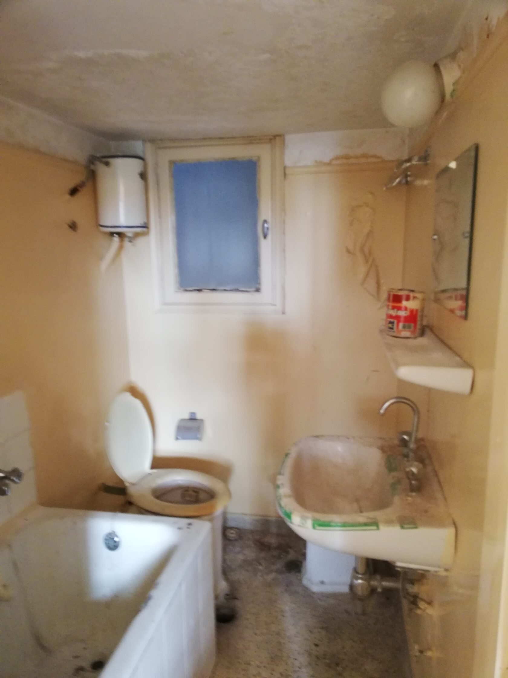 Bathroom before renovation, small tiles, dim