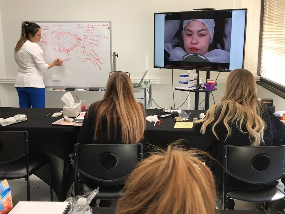 Delta students in a theory session with Kristina at the whiteboard