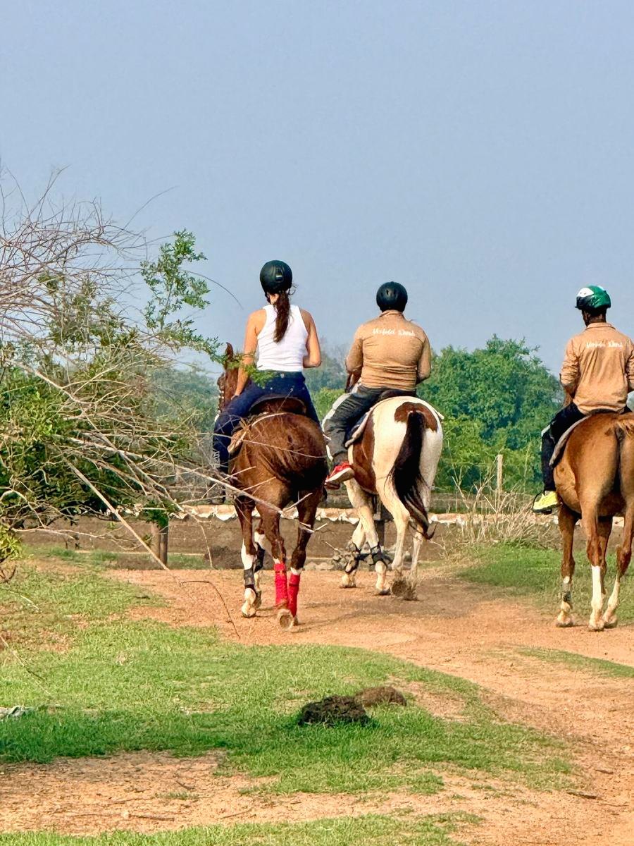 Guest riding between two Vonfidel Ranch guides on a private trail in Sri Lanka