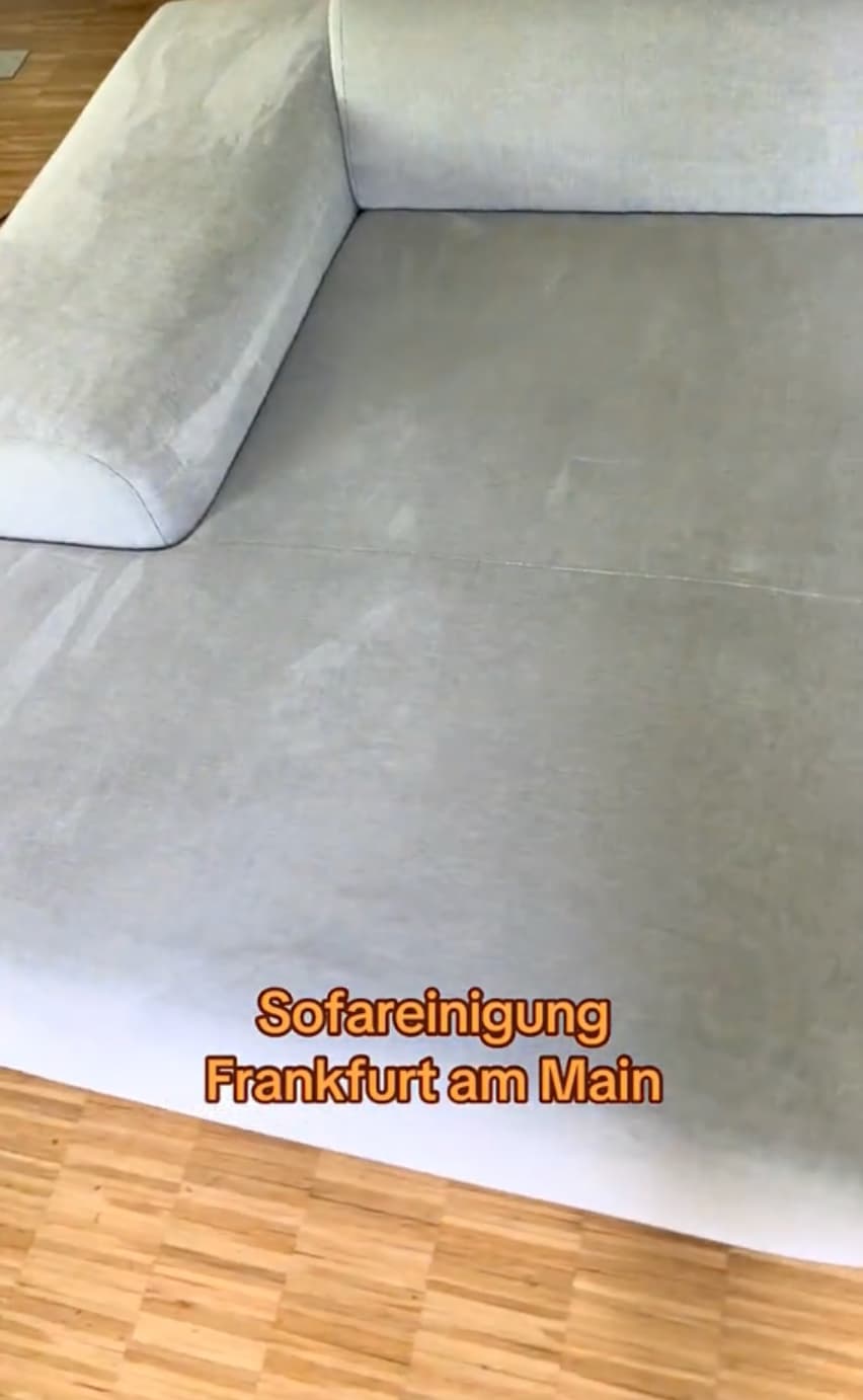 Große hellgraue Wohnlandschaft mit Steppung während der Reinigung