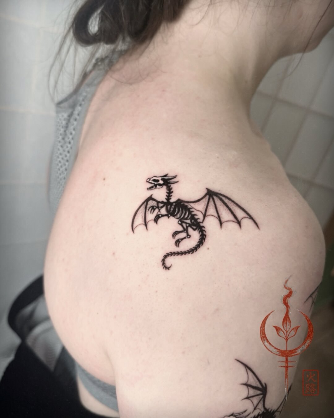 Kleiner geflügelter Drache am Oberarm