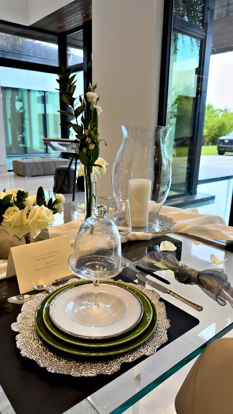 Each place set under a glass cloche — a time capsule birthday dinner at home by private chef Marina Staver in Miami