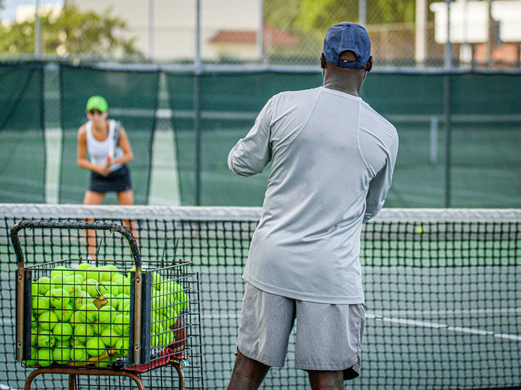 Coach working one-on-one with a junior player during a clinic