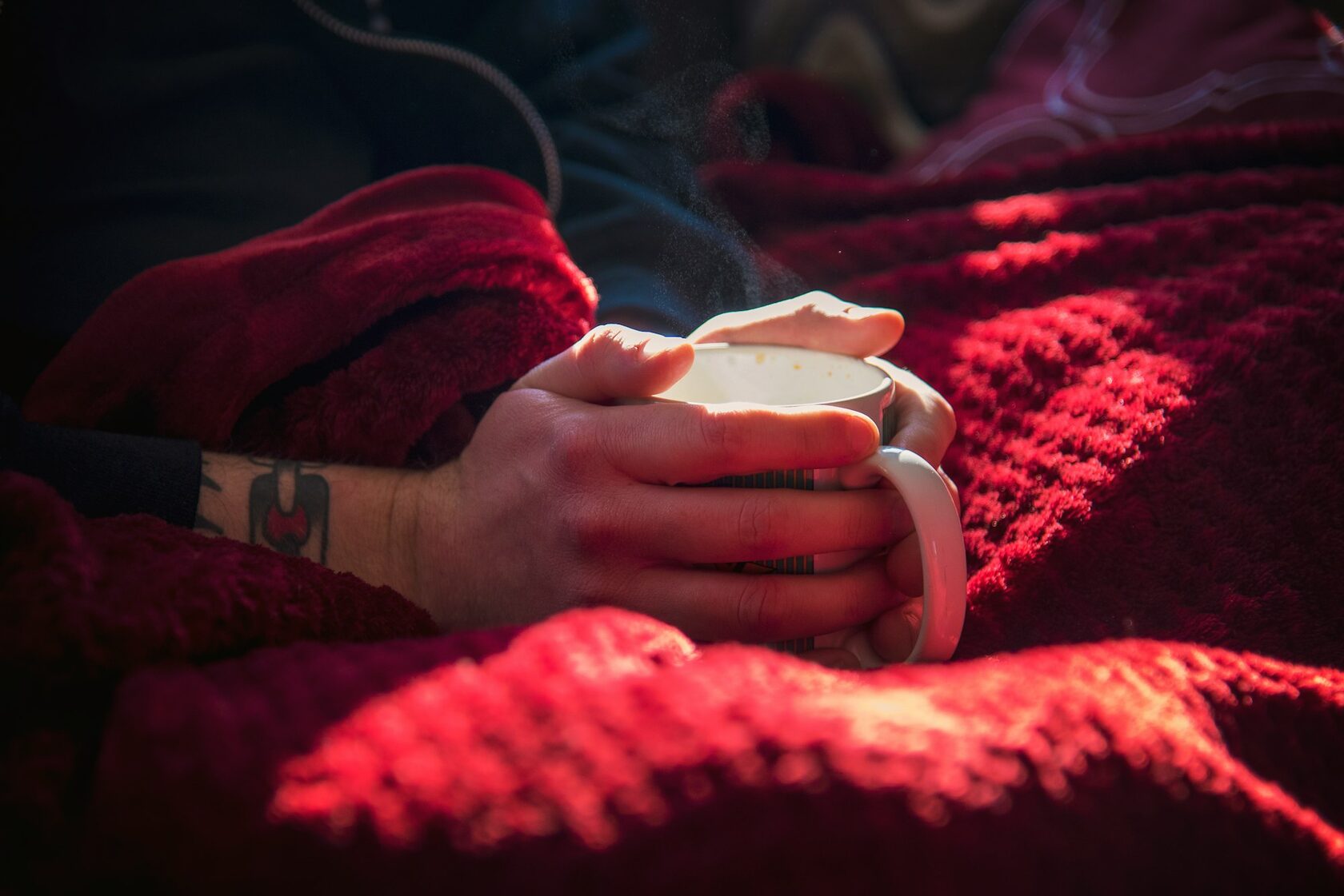 Hands holding a cup