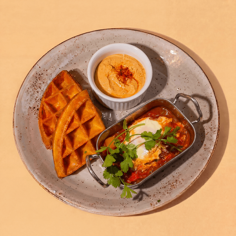 Shakshuka with hummus and waffles