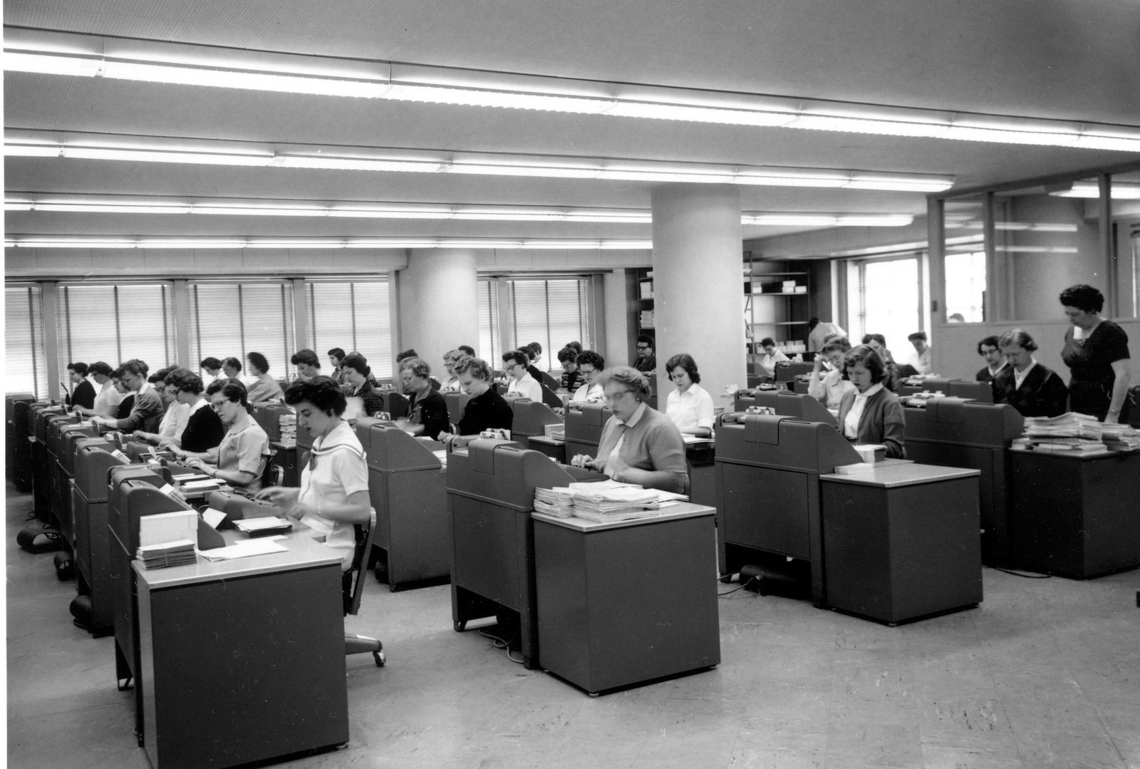 Archive photograph of a large typing pool: dozens of women typing documents at rows of desks