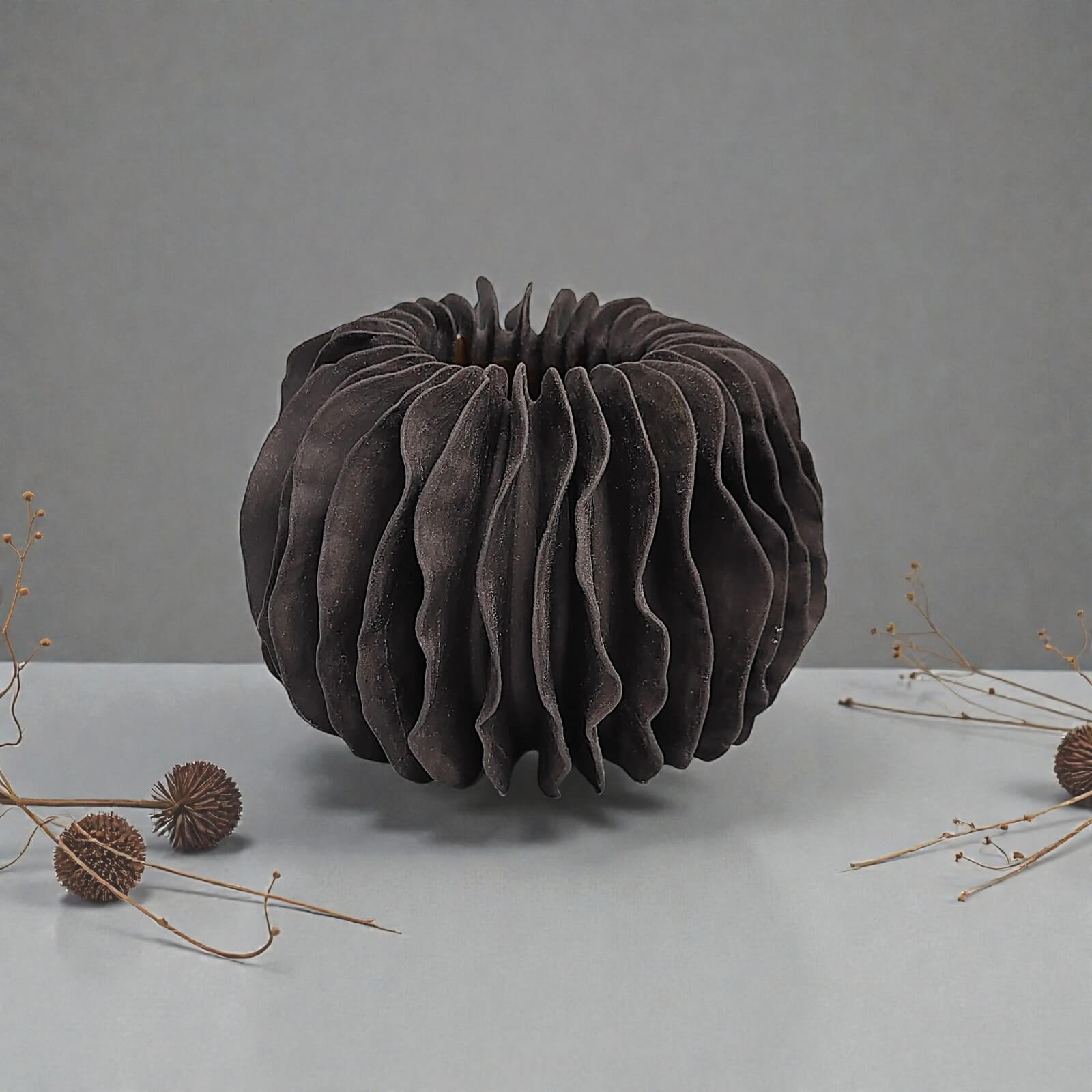 unique handmade black ceramic vase featuring a sculptural wavy, pleated texture, modern artistic home decor