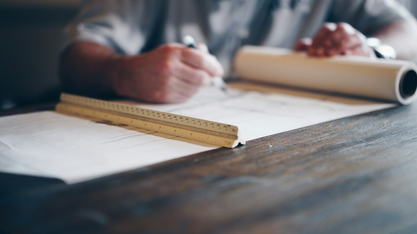 Video poster: measuring the site with plans on the table