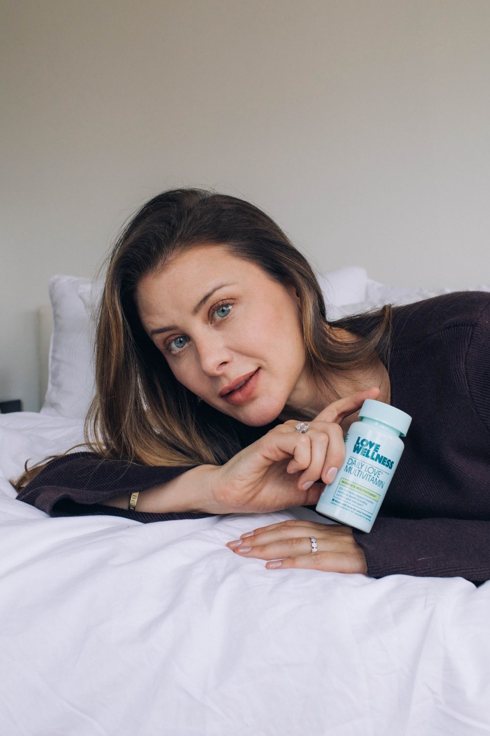 Lo holding a bottle of Daily Love Multivitamin