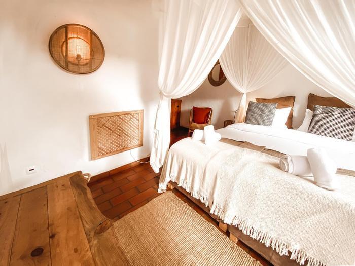 A Garden Suite bed, draped in soft linen