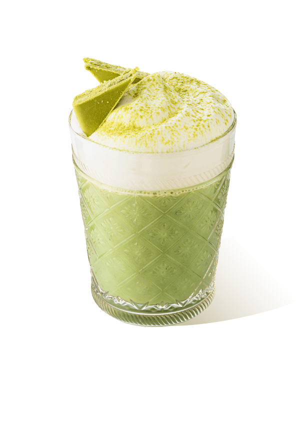 Iced matcha latte in a glass with creamy foam and matcha chocolate garnish, made with The Base Beverage matcha powder