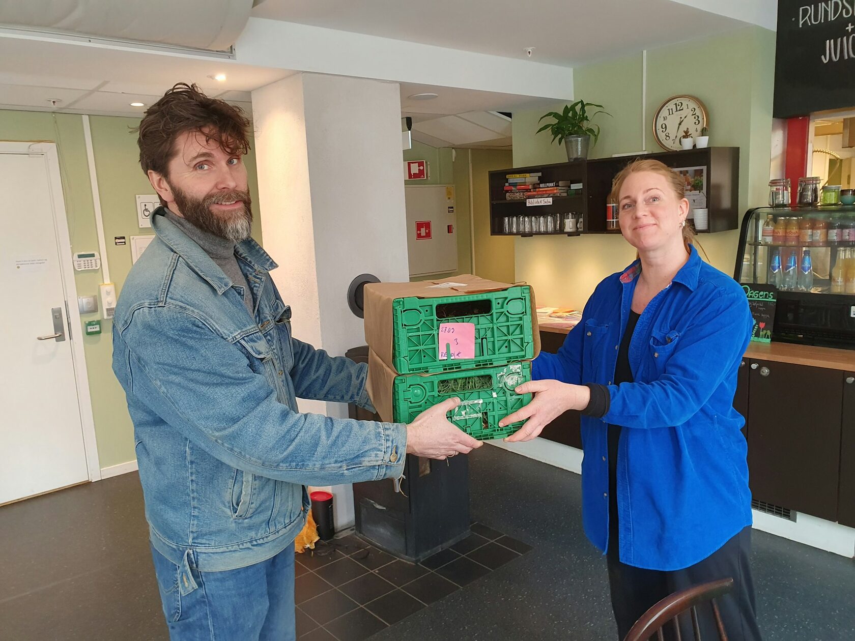 A customer receiving her weekly fruit box at the door.