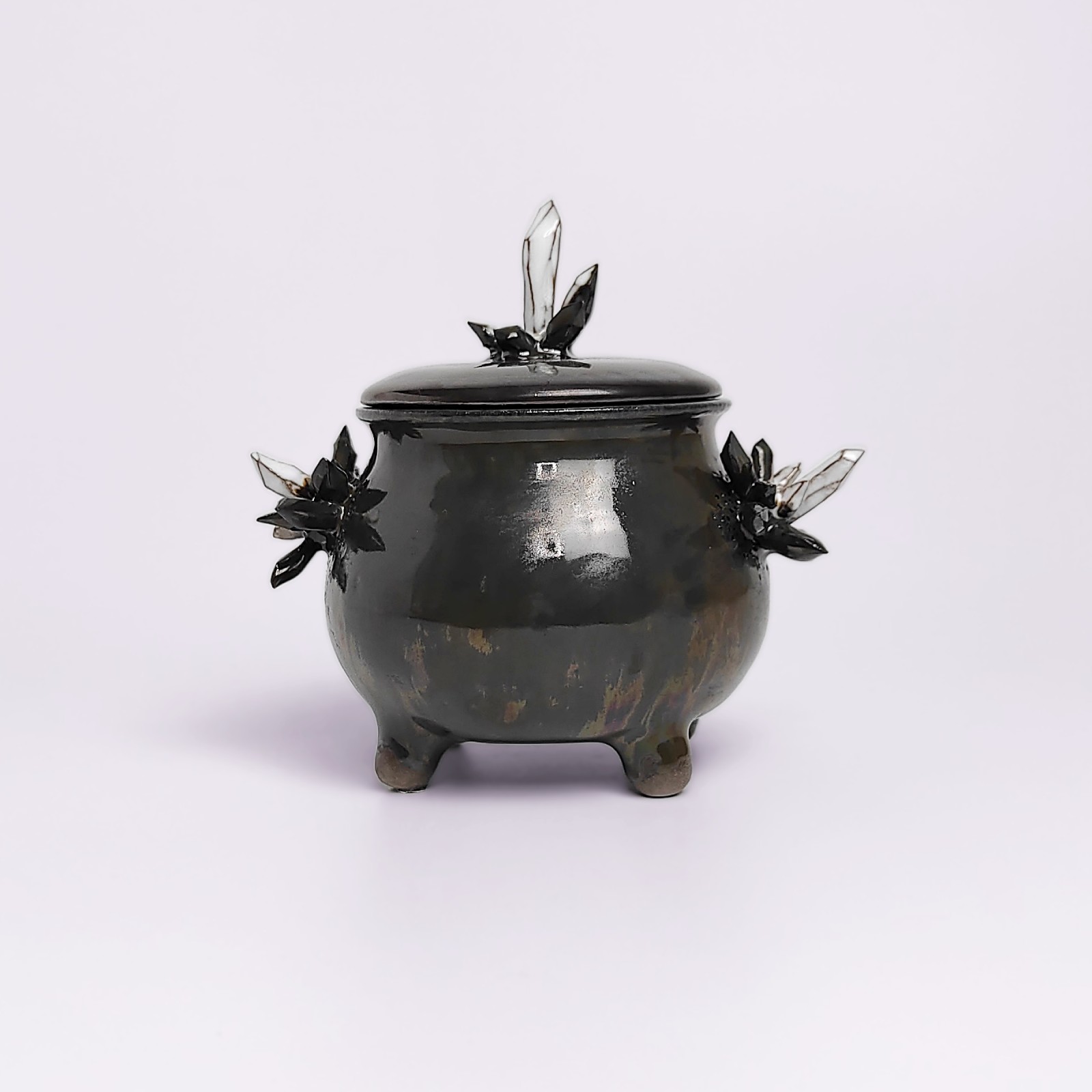 unique handmade ceramic witchy pot with a sculpted eye, black crystal accents, and a smoky dark glaze