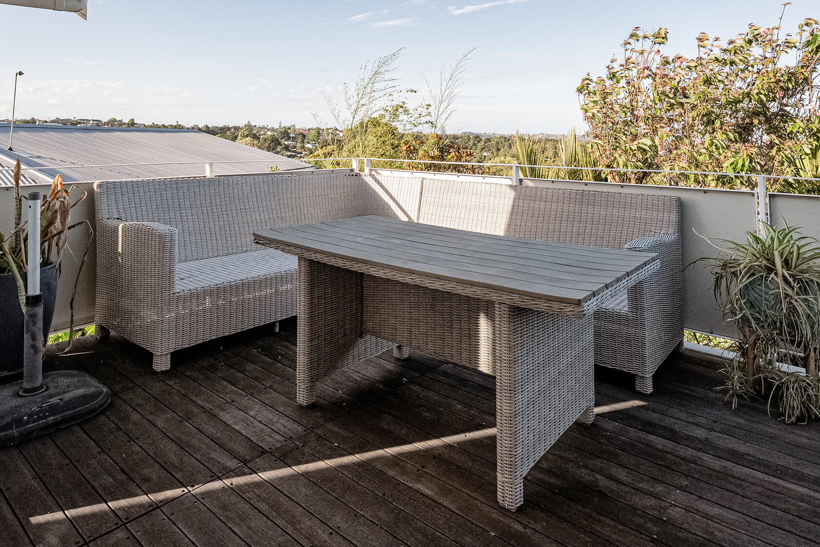 Glenfield outdoor deck with seating and a table beside the home