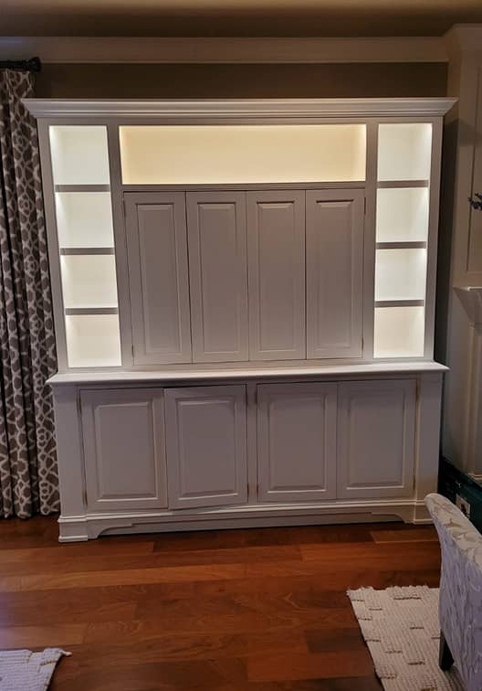 Front view of Classic entertainment and display cabinet with concealed TV and lighted shelves