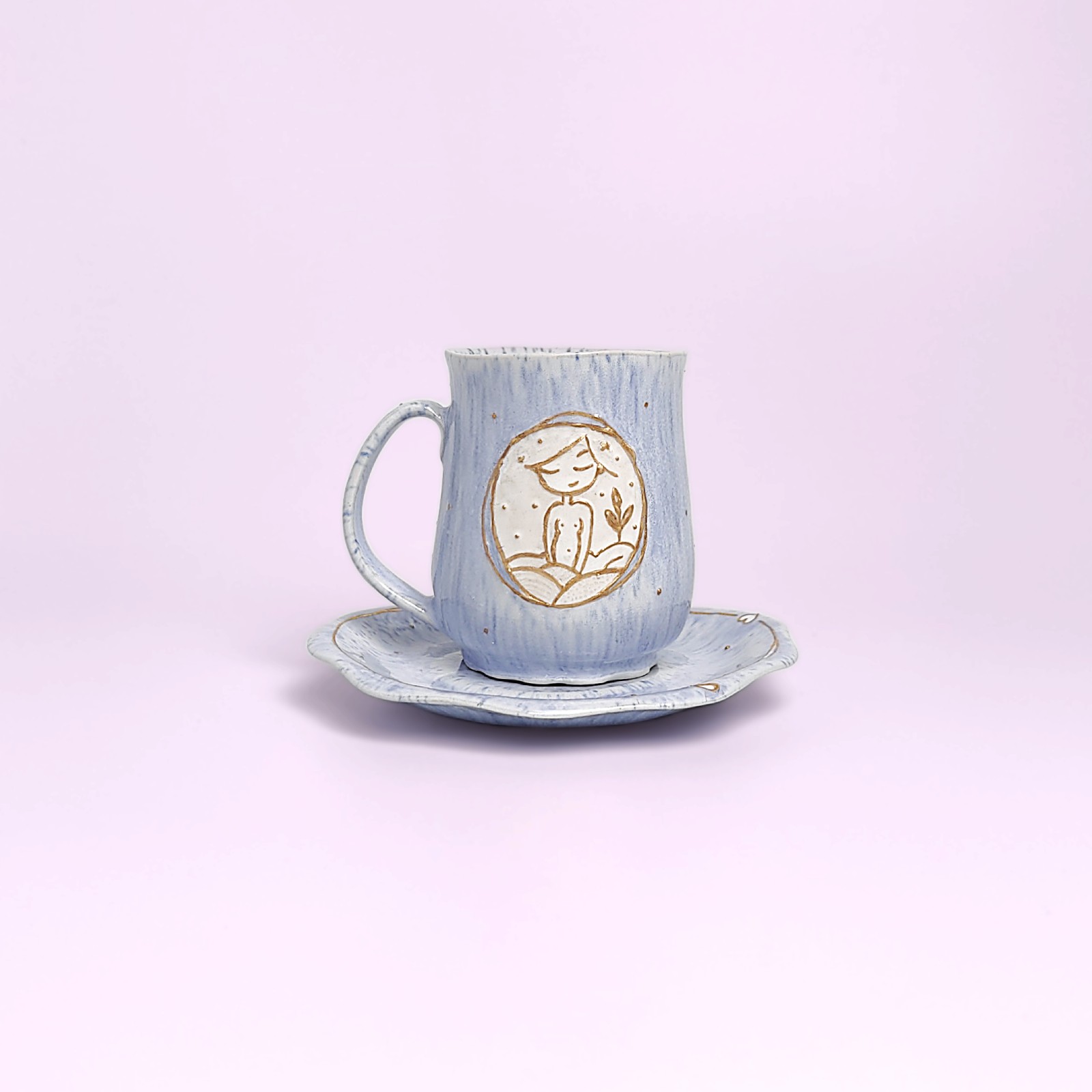 Artistic handmade ceramic cup and saucer in soft blue glaze with a girl medallion — a unique one-of-a-kind piece