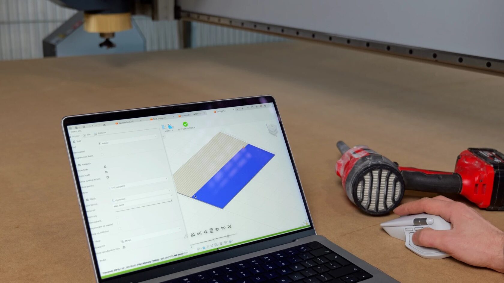 Cutting simulation on a laptop next to the CNC machine