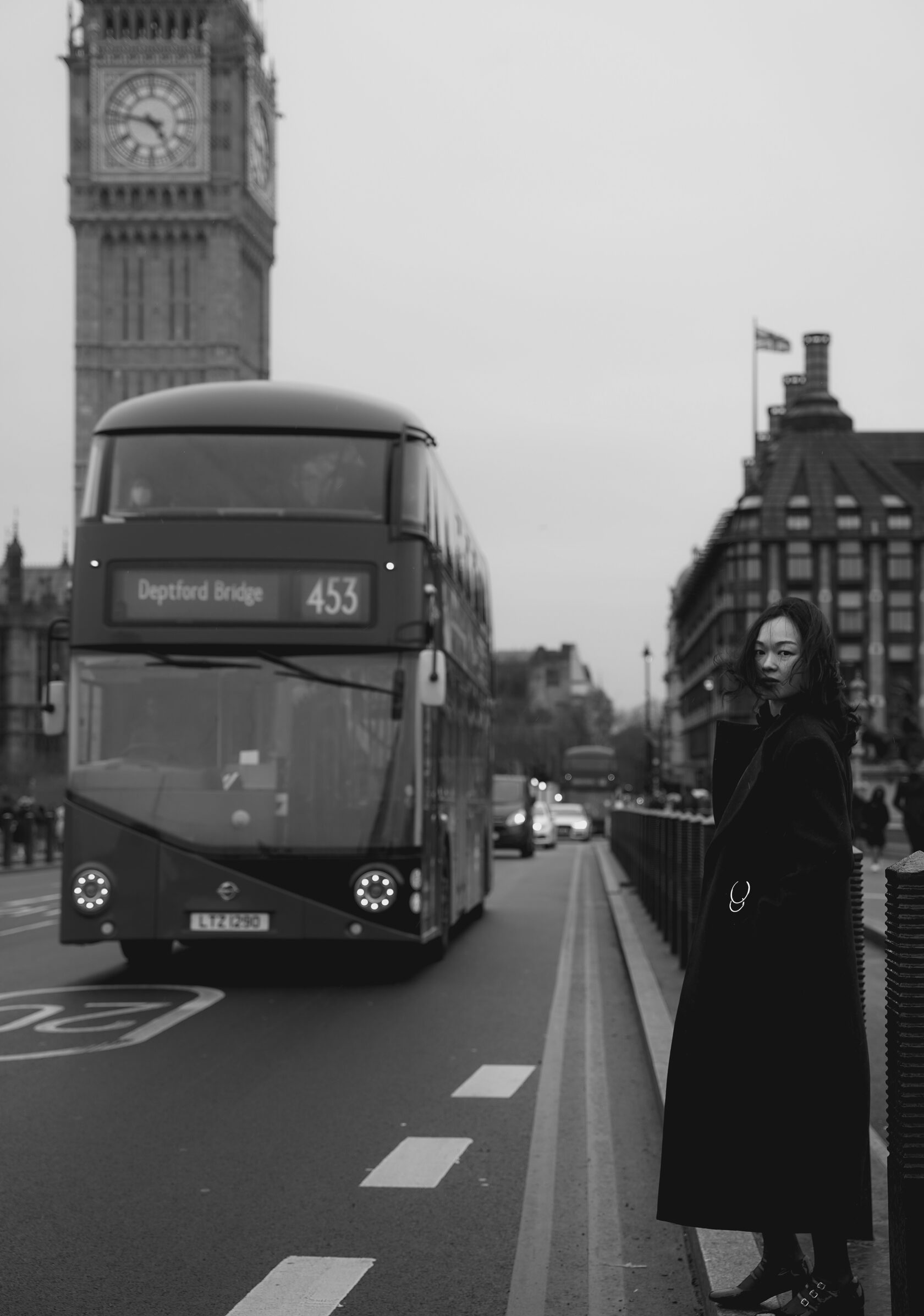 Black and white portrait beside a London bus and Big Ben
