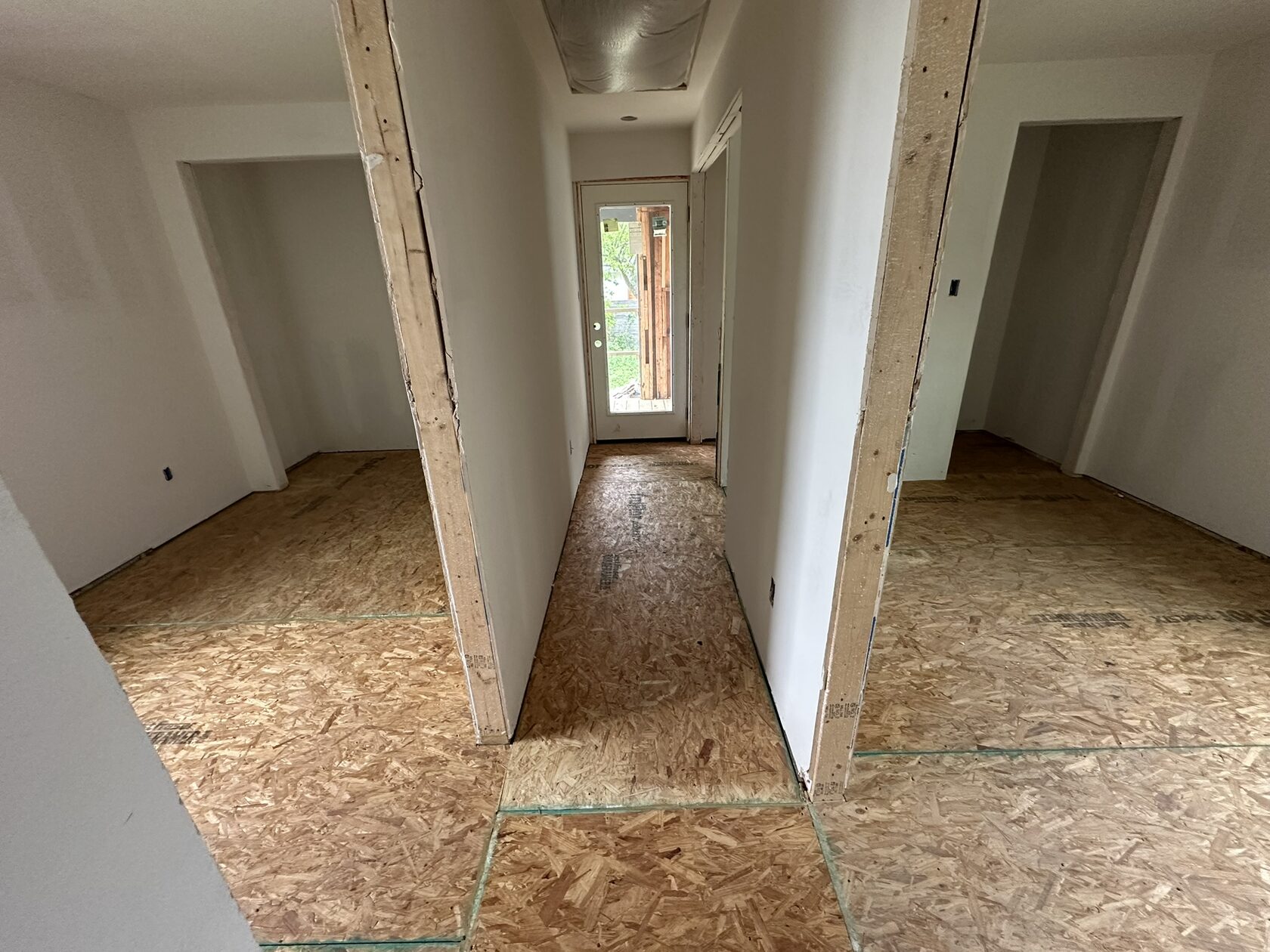 New OSB subfloor · Hallway preparation — Austin house flip by Kir Remodeling