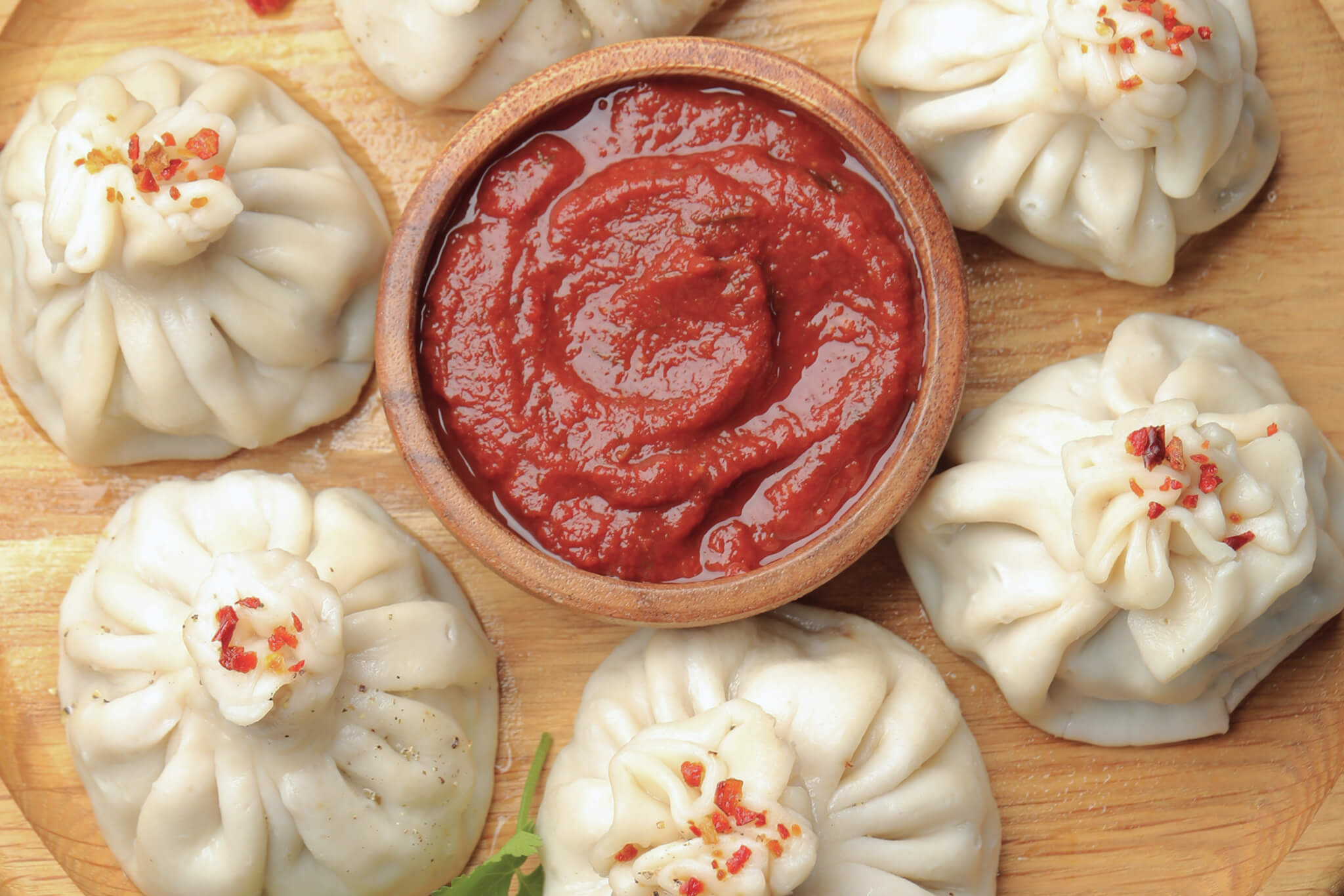 Georgian khinkali served with spicy red dipping sauce