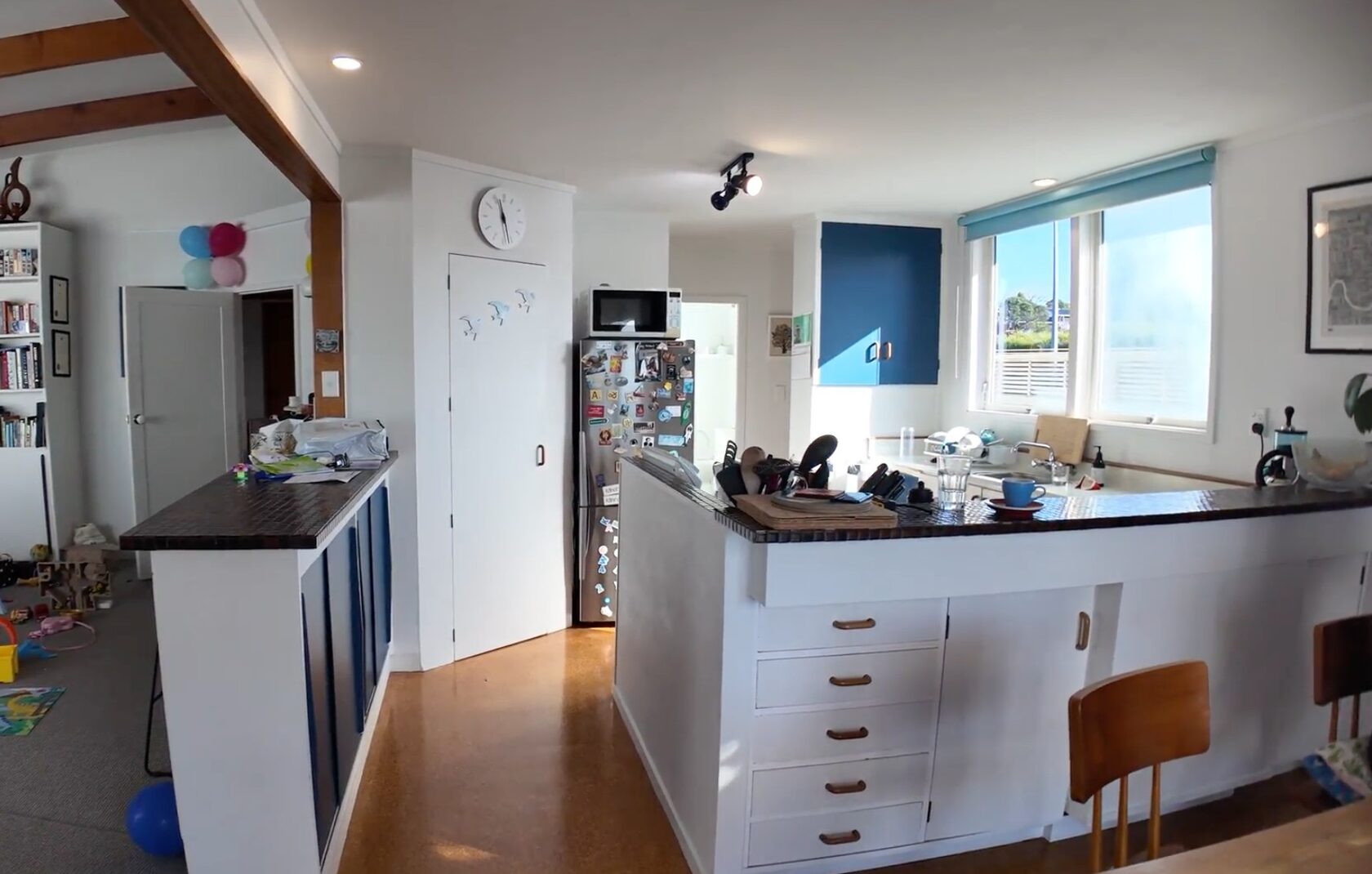Before: Hillcrest kitchen with a peninsula, white cabinetry and small internal doorway