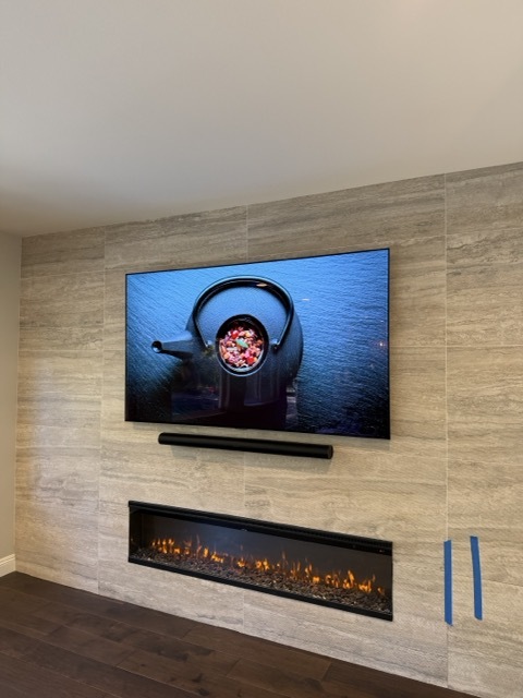 Floating TV on stone tile wall