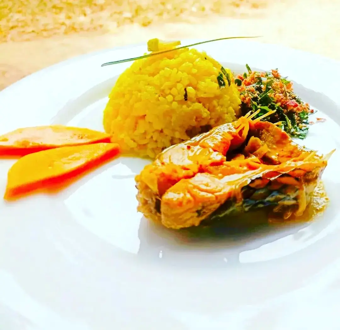 Fish served with tropical rice, mango, and herbs at Vonfidel Ranch