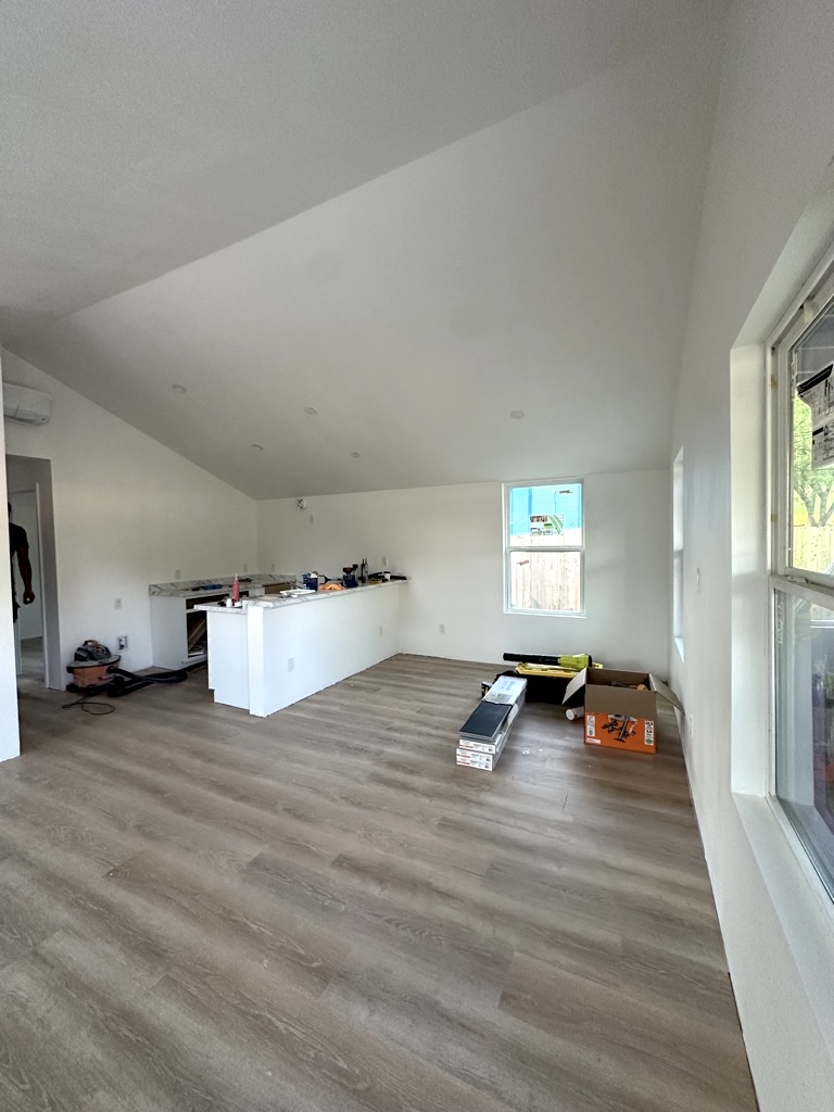 LVP flooring and painted living area · Kitchen work in progress — Austin house flip by Kir Remodeling